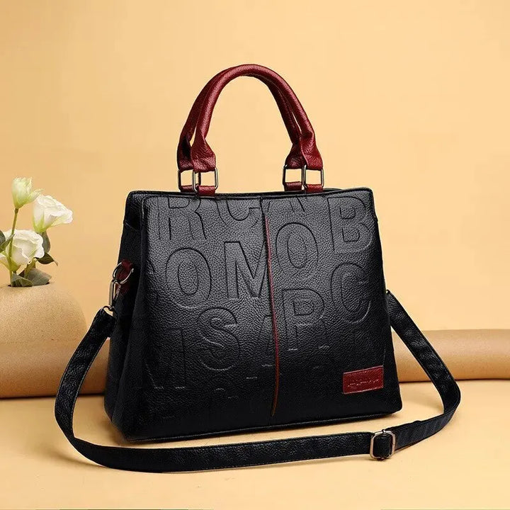 Ladies' handbag in soft leather with embossed letter design